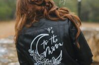 49 a classy black leather jacket with white calligraphy and a painted moon with blooms is a catchy idea for a celestial bride