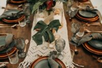 55 a macrame wedding table runner and centerpieces of tropical leaves for a boho tropical wedding