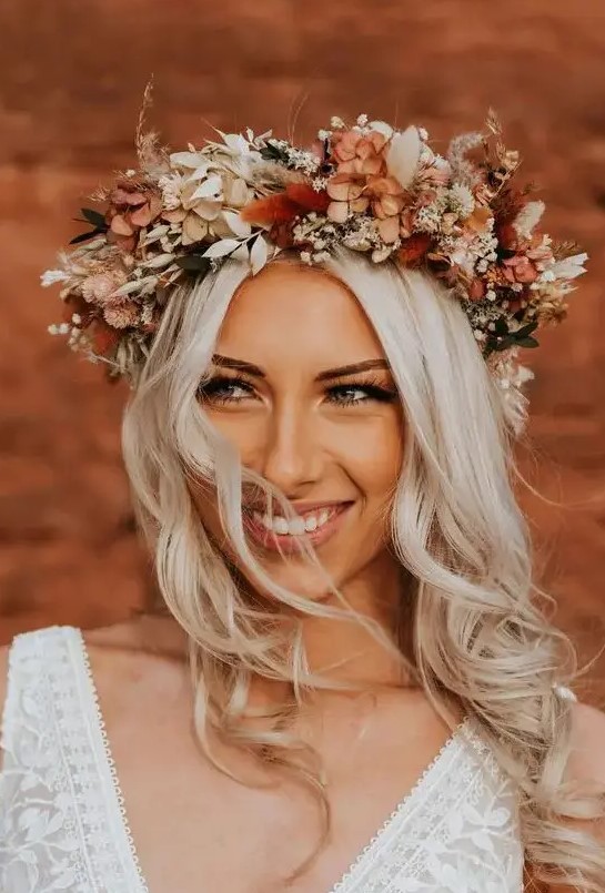 a beautiful boho fall wedding crown with lots of dried blooms and foliage, in rustic and creamy shades is a fantastic idea