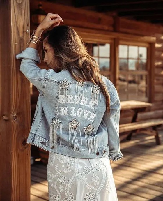 a bleached denim jacket with letters, embellished stars with long crystal fringe is a super cool boho and glam idea