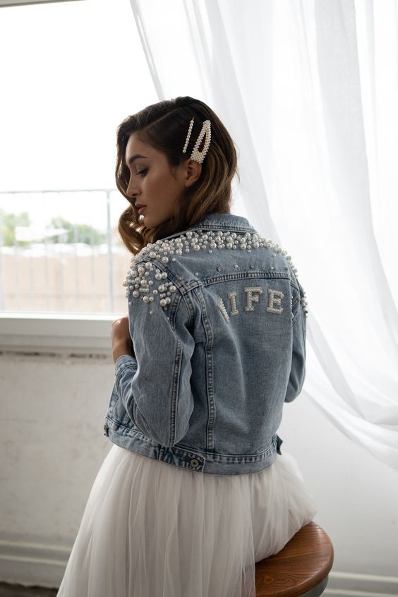 a blue denim Wifey jacket with lots of pearls covering the shoulders and the word done with pearls, too, for a tomantic look