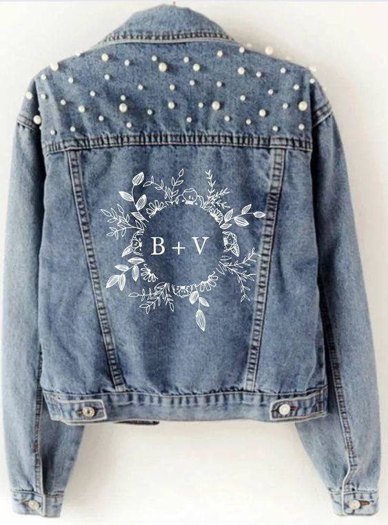 a blue denim jacket with hand painting and pearls over the shoulders is a cool idea for a glam boho bride