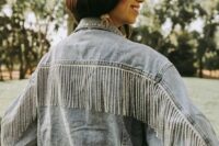 a blue oversized denim jacket with crystal fringe is a cool idea for a boho bride who loves a bit of glam