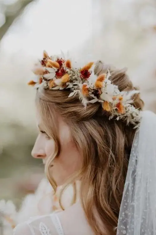 a dried flower crown with neutral, rust and burgundy bunny tails and leaves plus a polka dot veil for a fall boho bride