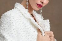 a jaw-dropping fully pearl embellished white bridal jacket and statement earrings will make your wedding look unforgettable