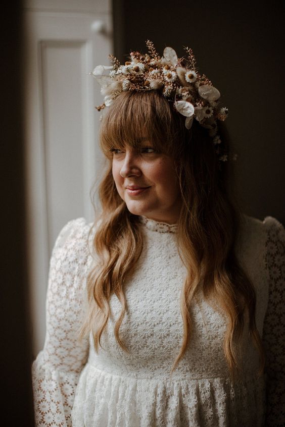 a lovely and subtle white dried flower crown with herbs is a stylish idea for a bride who is going for neutrals