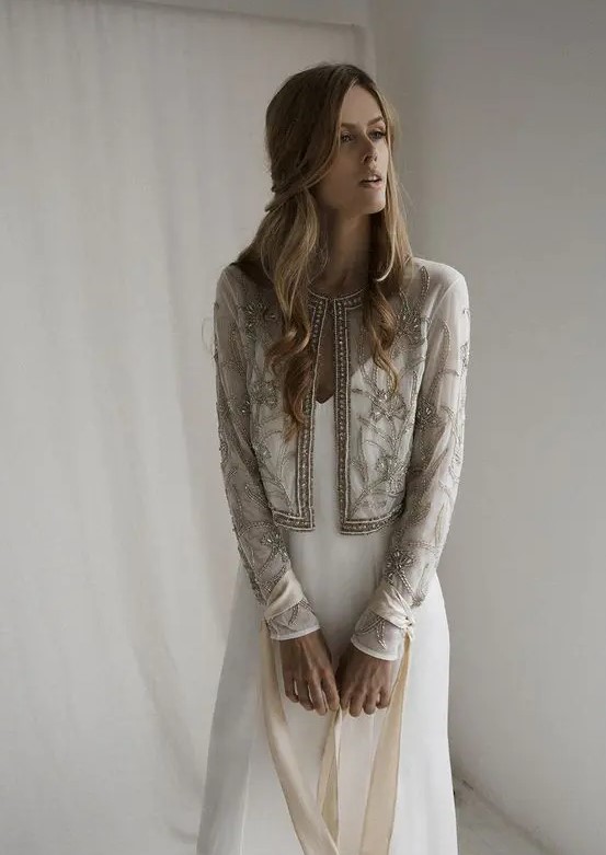 A lovely vintage inspired neutral bridal jacket with embroidery and embellishments is a chic addition to your bridal look