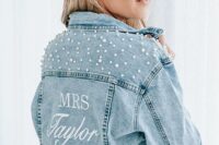 a stylish blue denim jacket with MRS and pearls covering the shoulders is a cool idea for a boho bride