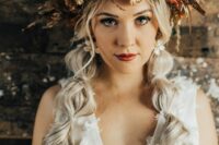 a super lush and bold dried flower crown done in rust, orange and neutrals, with herbs and leaves is a catchy idea for a fall bride