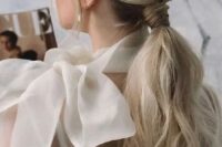 02 a beautiful and chic low ponytail with a braided touch, a bump on top and some waves down plus locks framing the face