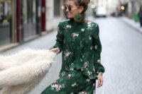 02 a beautiful and chic moody dark freen floral midi dress with long sleeves and ruffles, dark green heeled boots, green earrings and a faux fur jacket for a fall wedding