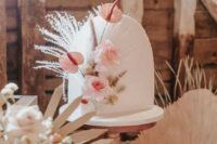 02 a beautiful arch white wedding cake decorated with blush blooms, grasses and seed pods is a great idea for a refined boho wedding in neutrals