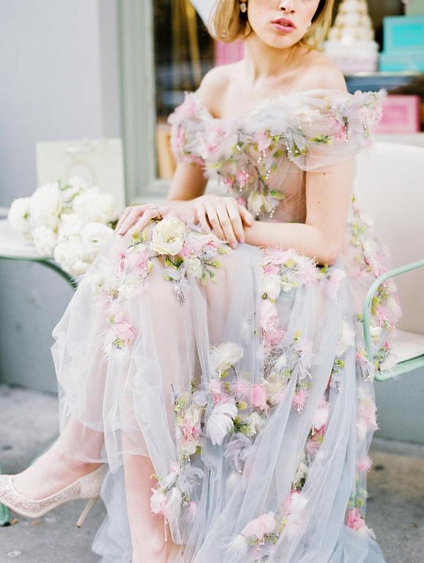 a beautiful off the shoulder semi-sheer wedding dress with pink and neutral floral applique and beading is amazing for spring