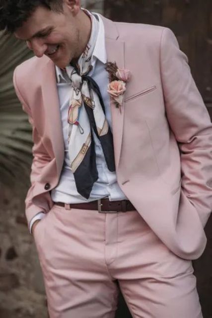 a blush pink groom’s suit paired with a white shirt and a neck tie looks fresh and very pretty