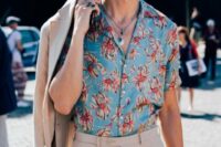 03 a bold tropical wedding guest look with a blue printed shirt, a tan linen suit and layered necklaces is cool and chic