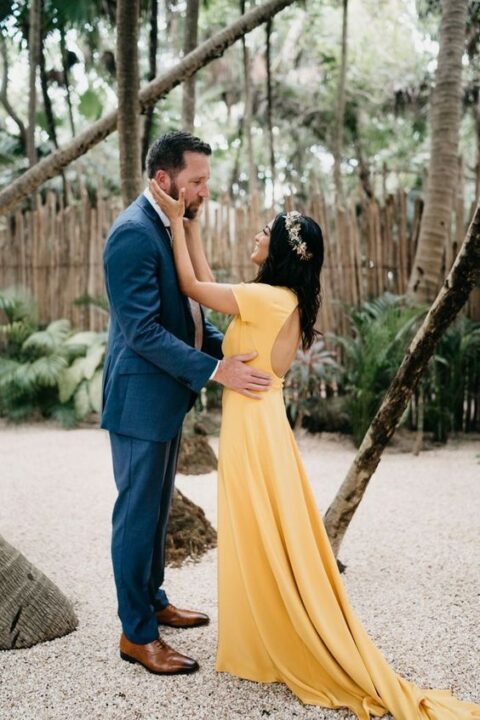 a bold yellow A-line wedding dress with a keyhole back, short sleeves and a train for a tropical wedding