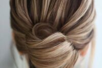 03 a chic and elegant French twist updo with a voluminous top and an elegant knot will fit medium length hair, too