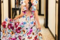 05 a beautiful bright floral maxi dress with an open back and ruffles instead of sleeves, purple shoes that match the print