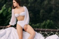 06 a white bikini with a high waisted bottom and sheer puff sleeves for a tropical bride