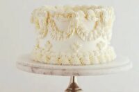 07 a delicate ivory lambeth wedding cake with no other details than sugar patterns is amazing for a refined neutral wedding