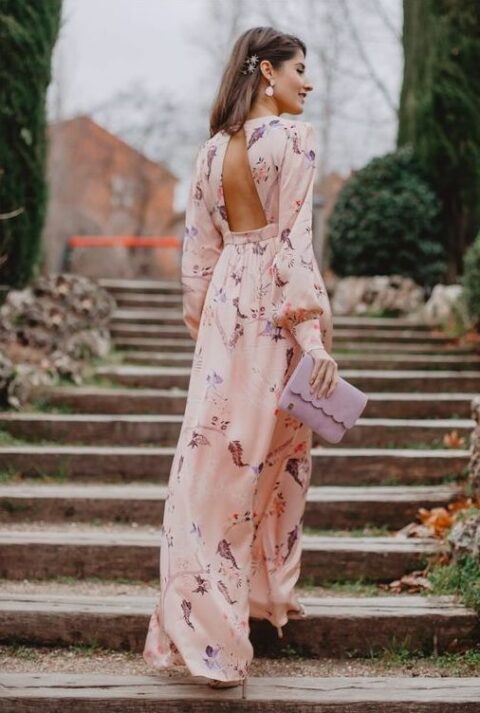 a blush maxi floral wedding guest dress with puff sleeves, a lilac clutch, blush shoes and blush earrings for a spring wedding