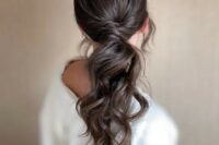 08 a dreamy wavy low ponytail with twisted hair and a sleek top plus locks framing the face is a lovely idea for a modern bride
