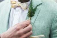 08 a light green linen blazer with a yellow bow tie and a fern boutonniere for a woodland wedding