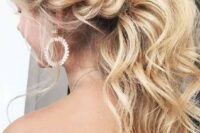 09 a gorgeous low wavy ponytail with a messy bump and a twisted braid on the side is a trendy idea
