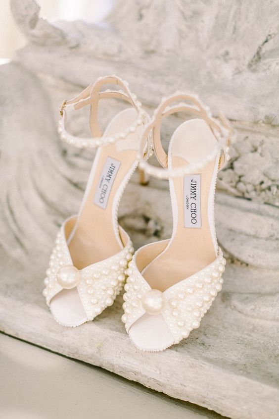beautiful embellished neutral wedding shoes with large and small pearls and pearl ankle straps are very chic and lovely