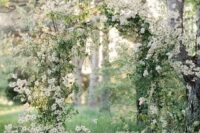 11 a gorgeous spring wedding arch fully done with white blooming branches just screams spring and blooms