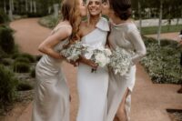 11 a minimalist one shoulder wedding dress with a large bow on the shoulder and a train, satin maxi bridesmaid dresses with side slits and mismatching sleeves and necklines