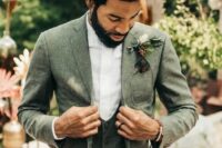11 an elegant green three-piece groom’s suit with a white shirt and a floral boutonniere is a lovely look to rock