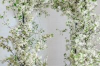 12 a jaw-dropping white blooming branches wedding arch is a gorgeous and absolutely amazing idea for a spring wedding
