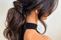 13 a jaw-dropping wavy messy low ponytail with a messy volume on top, locks framing the face is amazing for a glam bride
