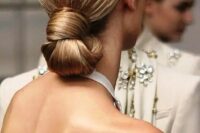 13 a perfect sleek knotted low bun is eye-catchy yet very simple and is ideal for a minimalist bride
