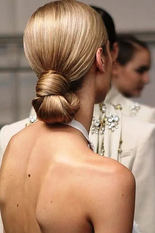 a perfect sleek knotted low bun is eye catchy yet very simple and is ideal for a minimalist bride