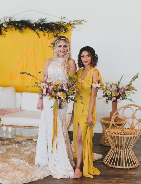 a yellow sleeveless wrap maxi bridesmaid dress and pink mules for a boho bridesmaid look