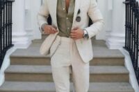 13 an effortlessly chic summer wedding guest look with an olive green shirt, a creamy linen suit, grey loafers and a chain