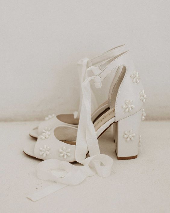 beautiful white wedding shoes with peep toes, pearl flowers and ankle straps are a chic and cool idea