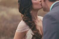 14 a long and curly side-swept ponytail in black and with brown balayage is a beautiful and refined idea for a wedding