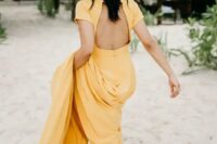14 a yellow A-line wedding dress with a cutout back, short sleeves and a train for a tropical bride