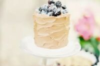 15 a neutral textural buttercream wedding cake topped with sugared berries is a fantastic idea for a summer wedding, it looks delicious