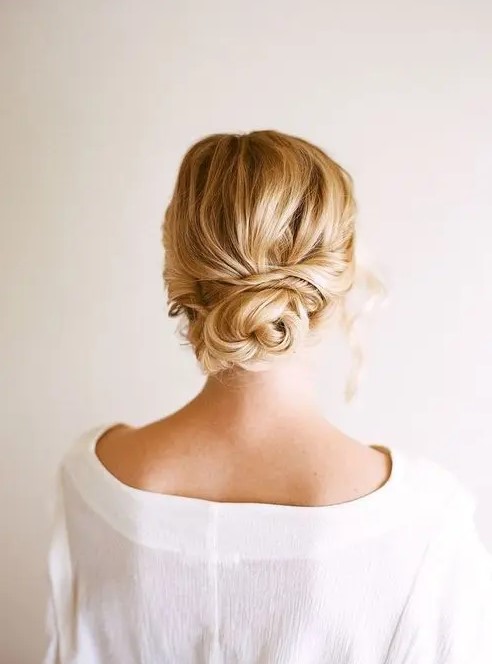 a simple twisted low bun is suitable for long and medium length hair