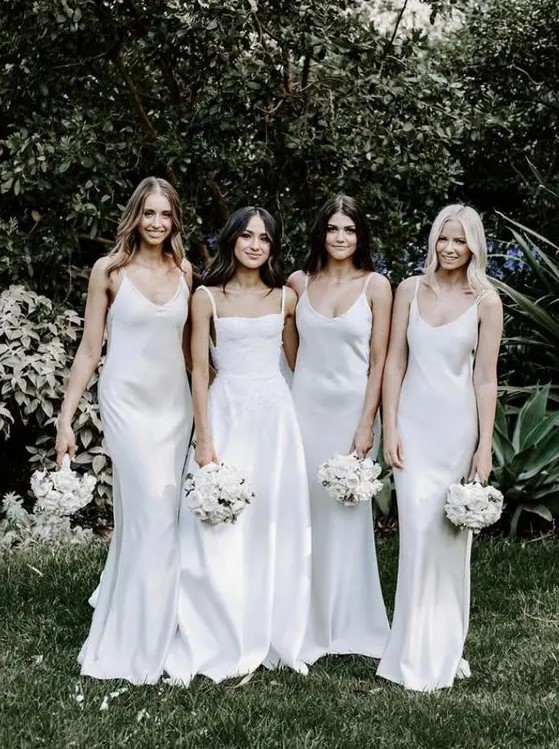 ivory slip maxi bridesmaid dresses with deep scoop necklines are a very edgy and trendy solution to rock