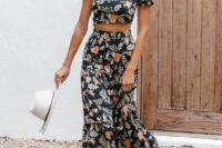 16 a chic black floral two-piece maxi dress with a one shoulder crop top, brown boots and a hat for a fall boho wedding