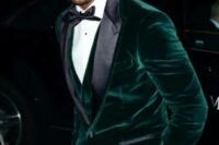 16 a chic fall or winter groom’s outfit with a green velvet blazer with black lapels, a waistcoat, a black bow tie and pants