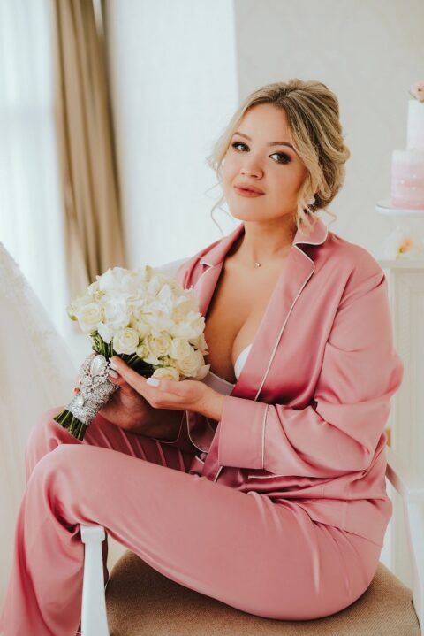 a pink silk pajama with white edges and a white bra for a romantic and beautiful bridal look