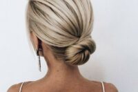 16 a sleek low bun with a bump is a cool idea is a great option for a minimalist or modern bride