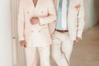 16 tropical wedding guest outfits, one with a creamy pantsuit and tan sandals, the second with a creamy suit, a blue shirt and creamy tie, a hat and brown loafers