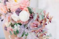 17 a gorgeous pastel wedding bouquet with lilac grasses, pink oversied blooms and orchids and some greenery